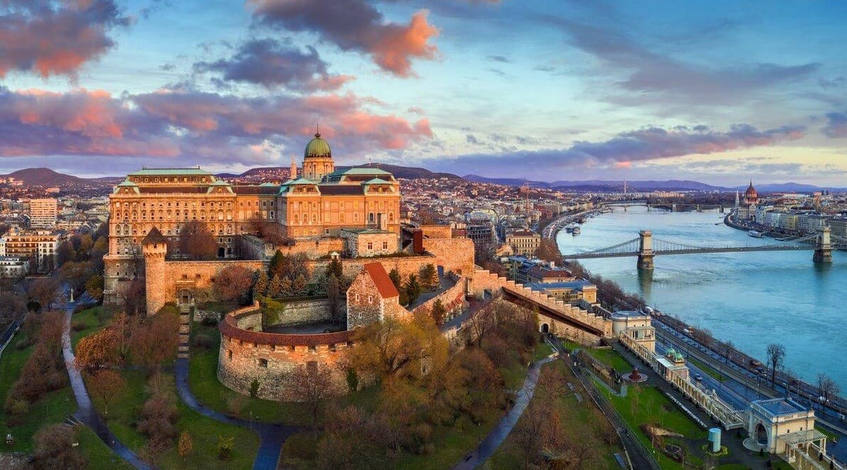 Buda Castle and its walls at sunrise above the Danube and the Chain Bridge